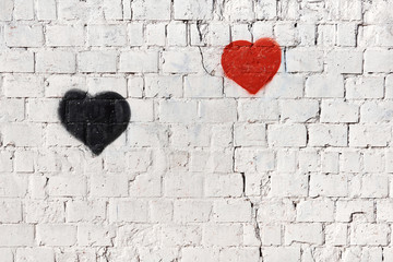 red and black heart on old white painted brick wall