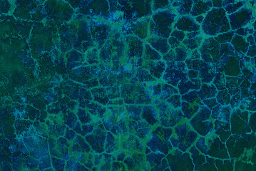 fantastic turquoise painted wall with cracks and peeling paint flakes