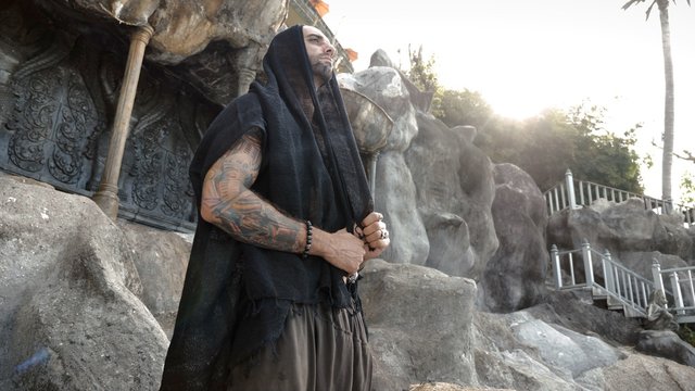 Oriental man posing outdoor in temple area
