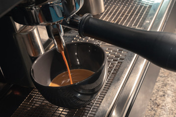 Fototapeta na wymiar making fresh espresso in coffee maker. coffee machine makes coffee