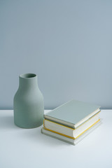 Minimalist book notebook and a plain vase 