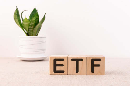 ETF Word With Building Blocks On A Light Background And A Green Flower