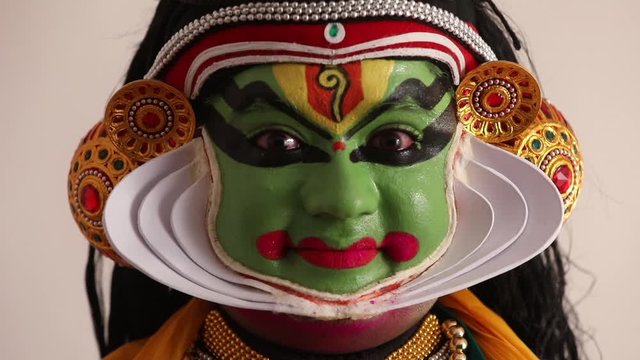 Close up of a Kathakali dancer representing Sringara through his eyebrows.  