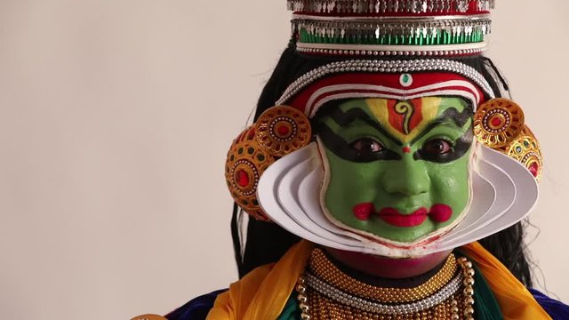 Close up of a Kathakali dancer representing Sringara through his eyebrows.  