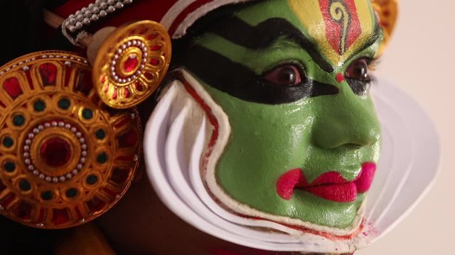 Close up of a Kathakali dancer giving expressions with his eyes. 