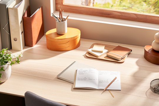 Stationery on table near window