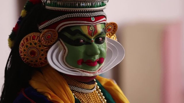 Close up of a Kathakali dancer smiling. 