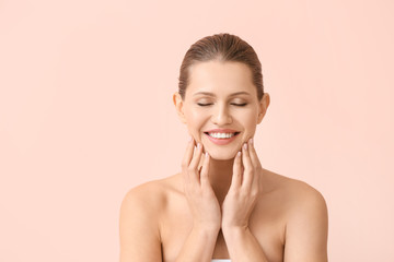Beautiful young woman on color background. Concept of plastic surgery