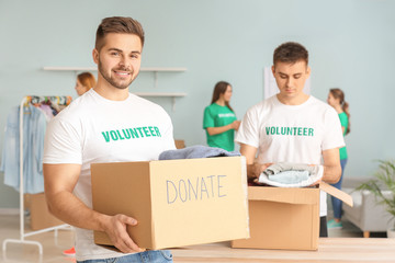 Volunteers with donations for poor people indoors