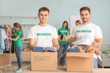 Volunteers with donations for poor people indoors
