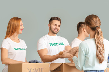 Volunteers with donations for poor people indoors
