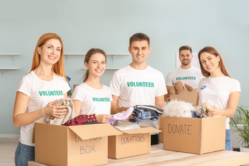 Team of volunteers with donations for poor people indoors