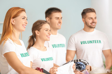 Team of volunteers with donations for poor people indoors