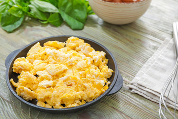 Frying pan with scrambled egg on table