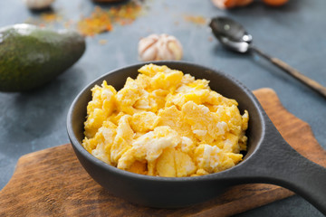 Frying pan with scrambled egg on table