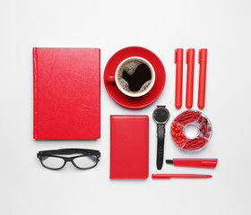Set of school supplies with cup of coffee on white background