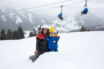 Fototapeta na wymiar Family, skiing in winter ski resort on a sunny day, enjoying nature