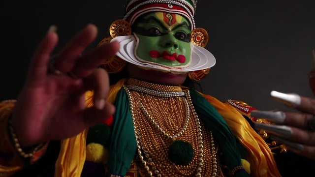Kathakali dancer standing gracefully in a stance. 