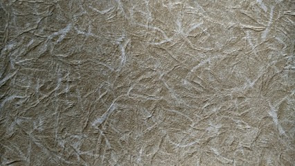 a photo of the pattern and texture of the brown wallpaper that adorns the walls