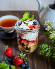 Healthy treat in the mason jar, vanilla pound cake with berries and mint leaves