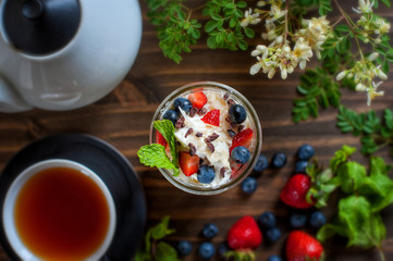Healthy treat in the mason jar, vanilla pound cake with berries and mint leaves