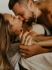 Beautiful loving couple kissing in bed