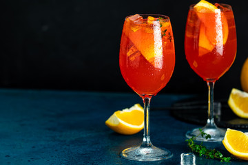 Color of 2020 year. Classic Blue, food trendy background. Two Aperol spritz cocktail in big wine glass with oranges, summer Italian fresh alcohol cold drink.