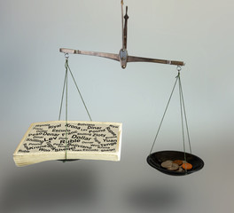 The concept of balance in business. Paper bills and metallic money are in balance on a balance.