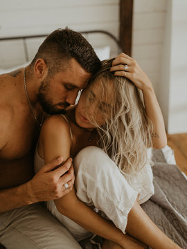 Beautiful loving couple kissing in bed