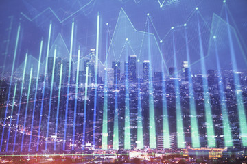 Financial graph on night city scape with tall buildings background double exposure. Analysis concept.