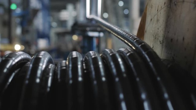 Manufacture of electric cable. Winding thick power cable in winding on a wooden reel.