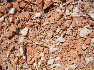 Broken red brick for background. Pieces of white concrete, dust.