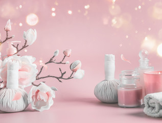 Spa background with body care tools , flowers and cosmetic at pastel pink background with blossom...