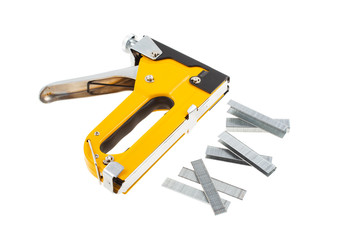 a staple gun and tree type staples isolated white background with path
