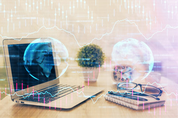 Stock market chart hologram drawn on personal computer background. Double exposure. Concept of investment.