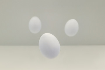 Flying easter white eggs on white background.