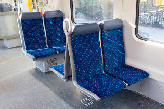 W&ouml;rthsee, Bavaria / Germany - Dec 29, 2019: Four blue seats inside a train. Interior decoration of an empty S-Bahn (Munich public transport). No people.
