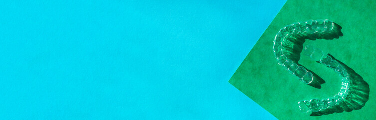 Invisible aligners teeth brackets on blue background