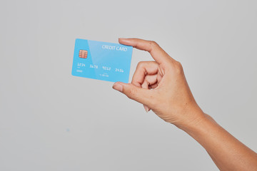 Human hand holding bank credit card