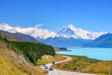 The road curves along Lake Pukaki and Mount Cook on a clear day at Peter's Lookout in the South...