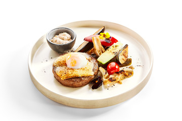 Steak with sous vide egg and baked vegetables
