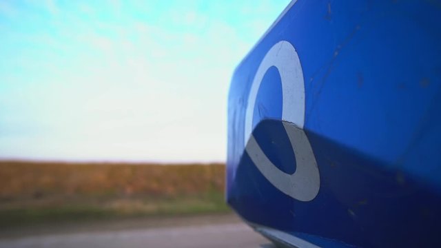 Zero road sign. Zero mile, kilometer. Check Point. Border of two countries. Equator. The beginning of the way. Fence on the cordon. Blue road sign. Traffic Laws. Travels. Tourism. Road for trucker.