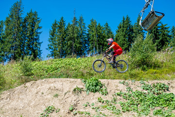 Obraz premium Professional cyclist on a mountain bike makes the jump, space.