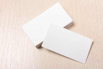 stacks of white blank business cards on a wooden surface