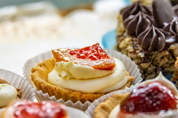 Cakes with cream, chocolate and fruit