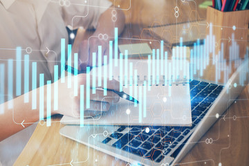 Financial charts displayed on woman's hand taking notes background. Concept of research. Double exposure