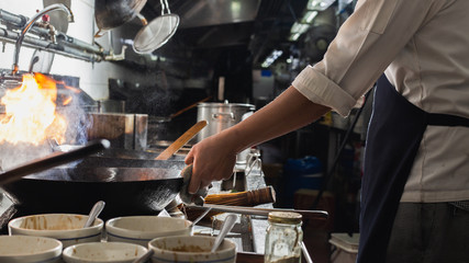 Chef stir fry cooking vegetable in wok