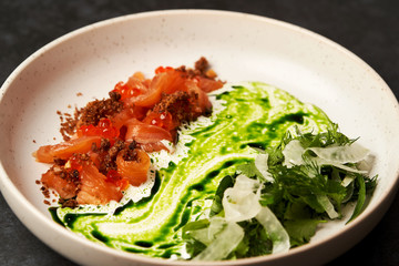 Seafood restaurant dish on dark background with copy space, close-up.