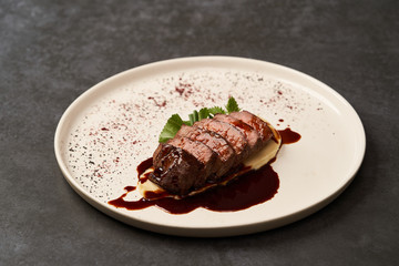 Filet mignon with mashed potatoes and pomegranate sauce, close-up