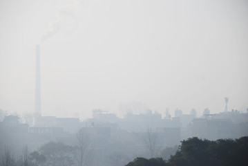 A foggy morning at Bhaktapur with the background of factory and buildings.